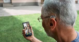 Person using phone with hearing aid